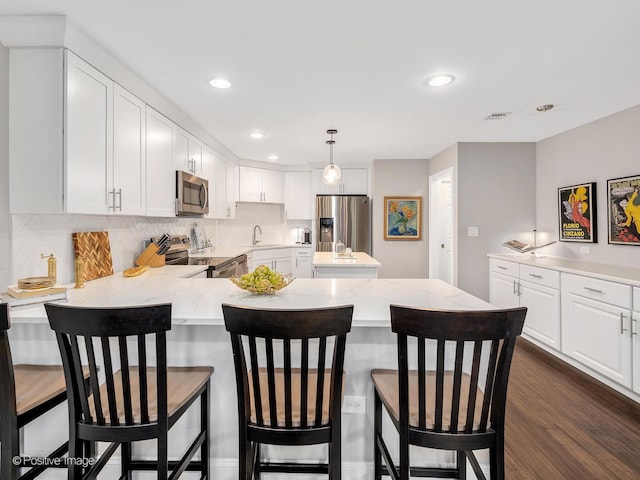1401 Burr Oak Rd Unit 312B, Hinsdale, IL 60521 - kitchen featuring stainless steel appliances, decorative backsplash, a peninsula, white cabinetry, and recessed lighting