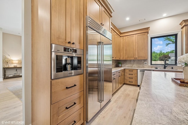 2104 Shermer Rd, Northbrook, IL 60062 - kitchen with appliances with stainless steel finishes, backsplash, light wood-style floors, light stone counters, and recessed lighting