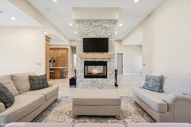 2104 Shermer Rd, Northbrook, IL 60062 - living room featuring a fireplace, recessed lighting, and light wood-style flooring