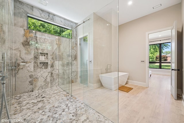 2104 Shermer Rd, Northbrook, IL 60062 - bathroom with a freestanding tub, plenty of natural light, a stall shower, wood finished floors, and recessed lighting