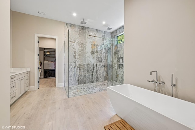 2104 Shermer Rd, Northbrook, IL 60062 - full bath featuring a stall shower, a freestanding tub, wood finished floors, a walk in closet, and recessed lighting