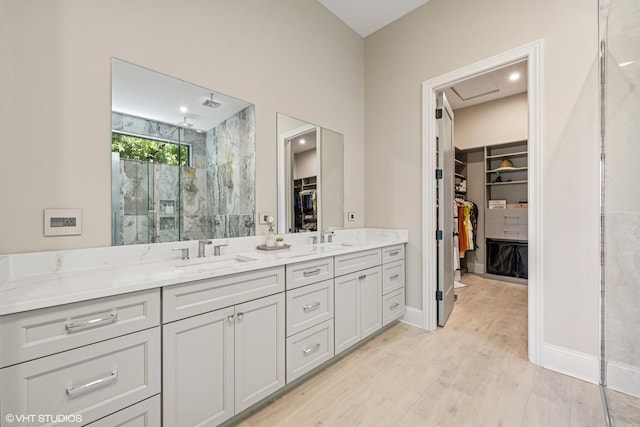 2104 Shermer Rd, Northbrook, IL 60062 - full bath featuring a marble finish shower, a walk in closet, double vanity, and wood finished floors