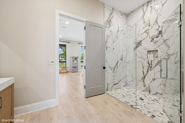 2104 Shermer Rd, Northbrook, IL 60062 - bathroom with a marble finish shower, vanity, wood finished floors, and recessed lighting