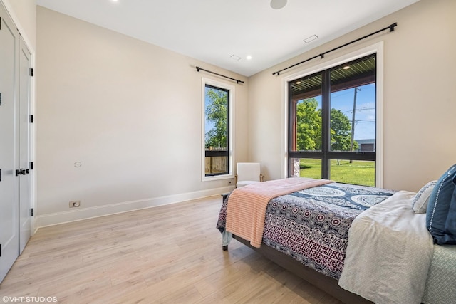2104 Shermer Rd, Northbrook, IL 60062 - bedroom with multiple windows, light wood finished floors, and recessed lighting