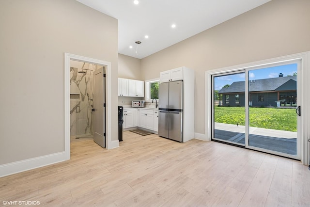 2104 Shermer Rd, Northbrook, IL 60062 - kitchen with freestanding refrigerator, white cabinets, light wood-style floors, light countertops, and recessed lighting