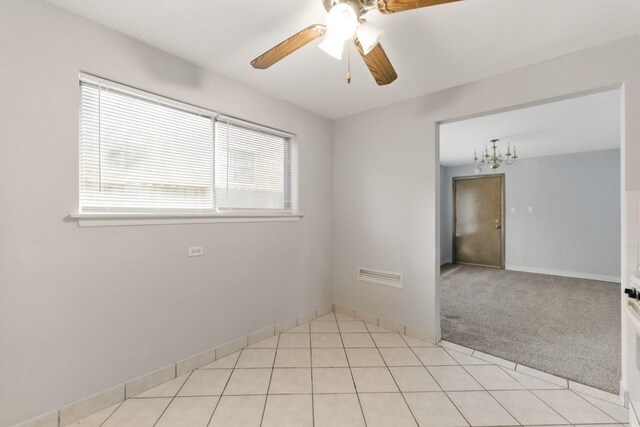 1111 N Harlem Ave Unit 1C, Oak Park, IL 60302 - empty room with plenty of natural light, a ceiling fan, light tile patterned floors, and a chandelier