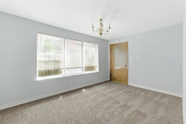 1111 N Harlem Ave Unit 1C, Oak Park, IL 60302 - carpeted empty room with a chandelier and baseboards