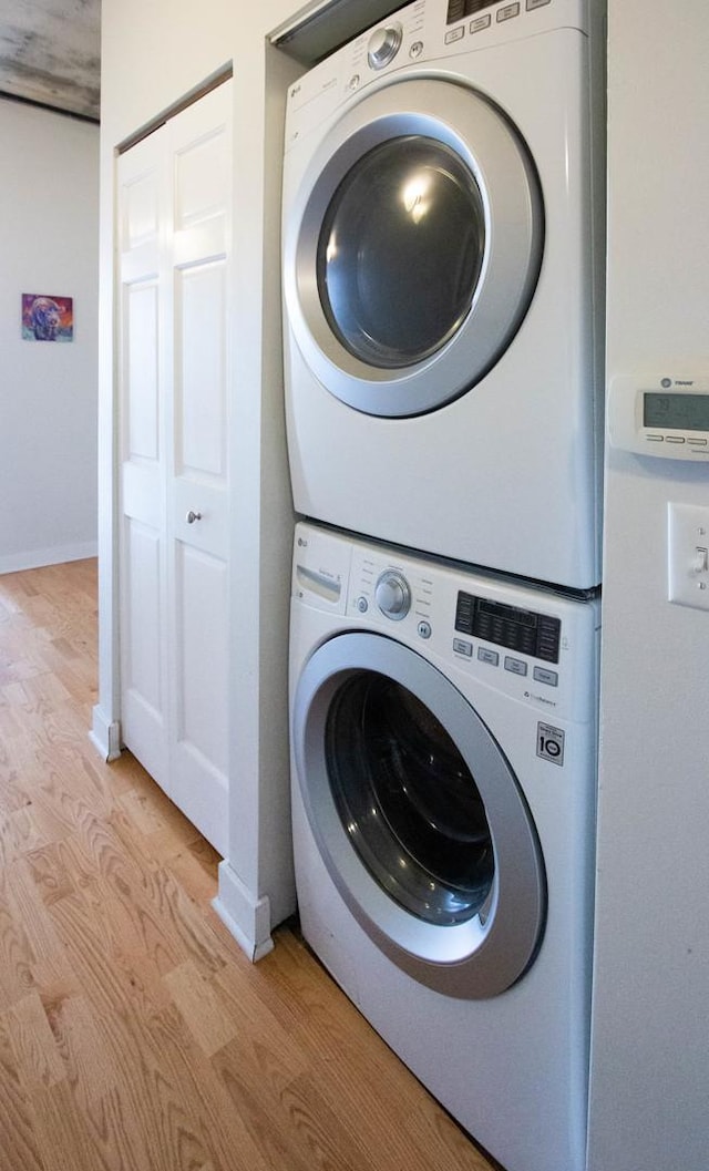 50 E 16th St Unit 311, Chicago, IL 60616 - laundry area featuring stacked washer and clothes dryer and light wood finished floors