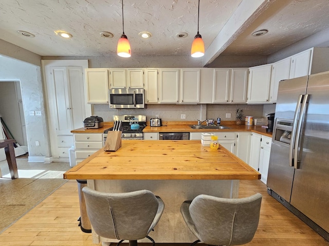 320 Congress St, Ottawa, IL 61350 - kitchen with appliances with stainless steel finishes, wood counters, pendant lighting, light wood-type flooring, and recessed lighting