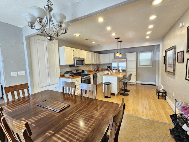 320 Congress St, Ottawa, IL 61350 - dining room featuring a textured wall, recessed lighting, a chandelier, and light wood-type flooring