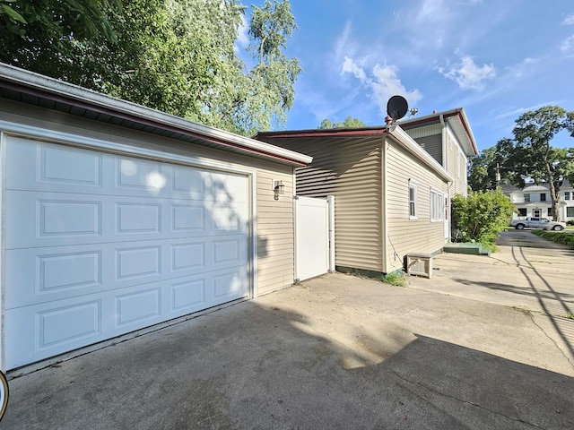320 Congress St, Ottawa, IL 61350 - view of property exterior featuring concrete driveway, a garage, and an outbuilding