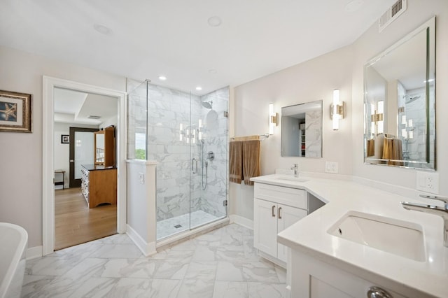 3801 Mission Hills Rd Unit 510, Northbrook, IL 60062 - bathroom featuring marble look tile flooring, a marble finish shower, vanity, recessed lighting, and a freestanding bath