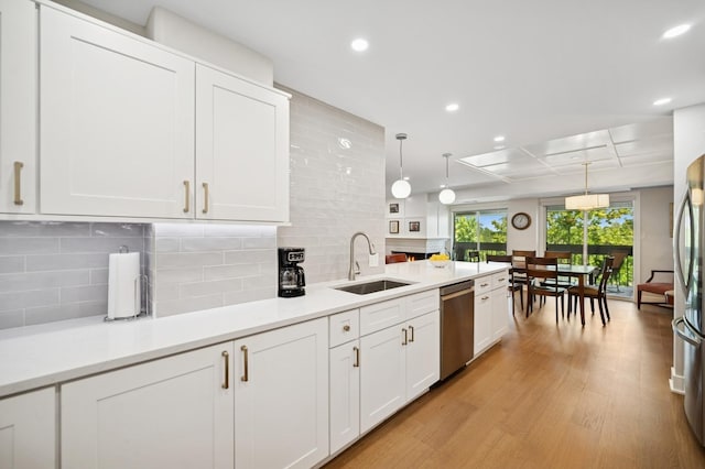 3801 Mission Hills Rd Unit 510, Northbrook, IL 60062 - kitchen featuring stainless steel appliances, white cabinets, light wood-type flooring, recessed lighting, and hanging light fixtures