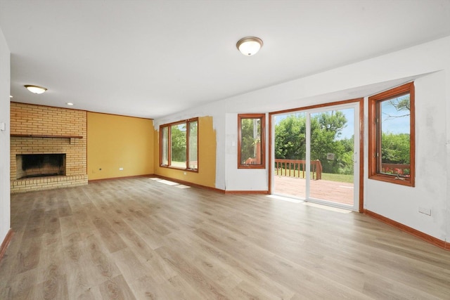 3057 201st Pl, Lynwood, IL 60411 - unfurnished living room with light wood-type flooring and a brick fireplace