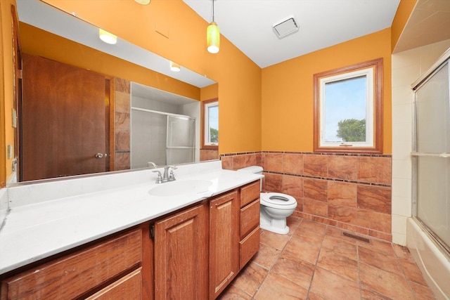 3057 201st Pl, Lynwood, IL 60411 - bathroom featuring tile walls, vanity, a wainscoted wall, and enclosed tub / shower combo