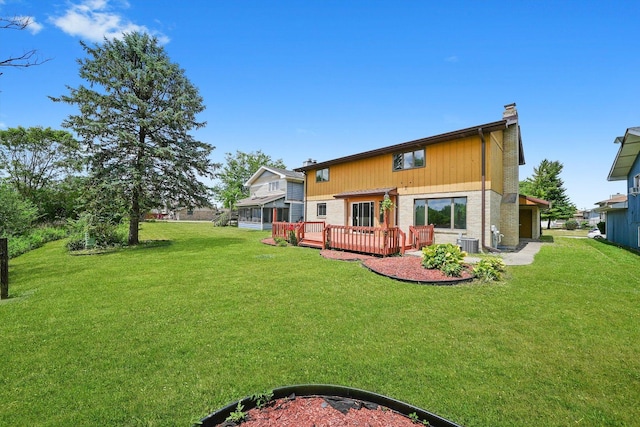 3057 201st Pl, Lynwood, IL 60411 - rear view of house featuring a chimney, a deck, and a lawn