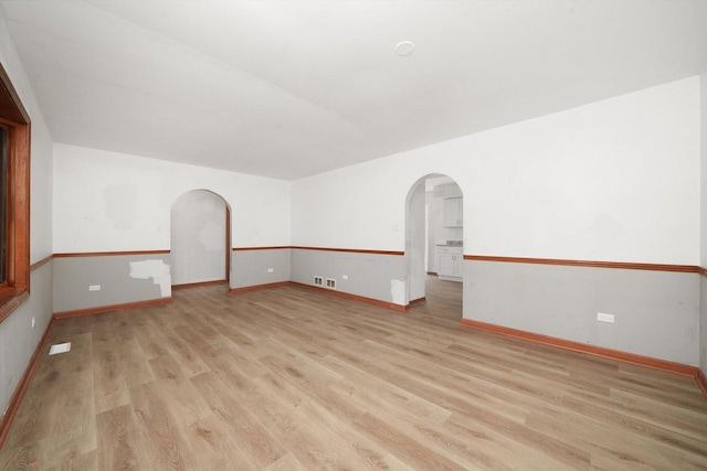 3057 201st Pl, Lynwood, IL 60411 - unfurnished room with arched walkways and light wood-style floors