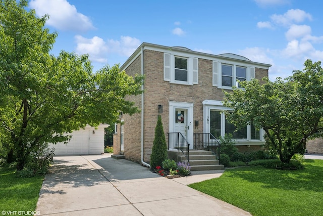 731 N Patton Ave, Arlington Heights, IL 60004 - multi unit property featuring a garage, a front lawn, an outbuilding, driveway, and brick siding