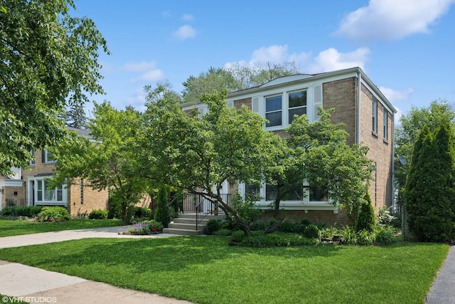 731 N Patton Ave, Arlington Heights, IL 60004 - obstructed view of property featuring brick siding and a front yard