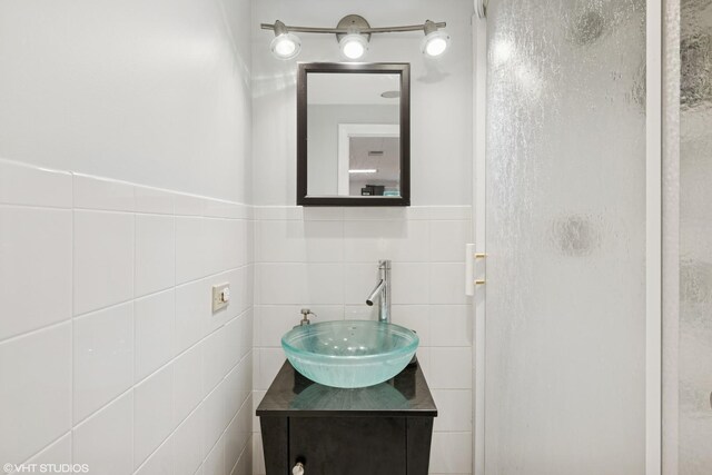 731 N Patton Ave, Arlington Heights, IL 60004 - bathroom featuring tile walls, a stall shower, vanity, and wainscoting
