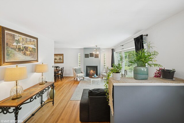 731 N Patton Ave, Arlington Heights, IL 60004 - living area with a lit fireplace, light wood finished floors, and ceiling fan
