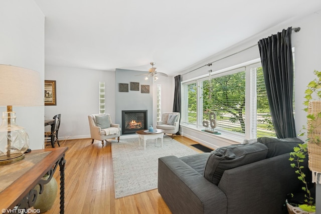 731 N Patton Ave, Arlington Heights, IL 60004 - living area with a lit fireplace, light wood-style flooring, and ceiling fan