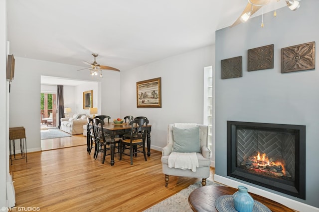 731 N Patton Ave, Arlington Heights, IL 60004 - dining space featuring a ceiling fan, light wood-style flooring, and a warm lit fireplace