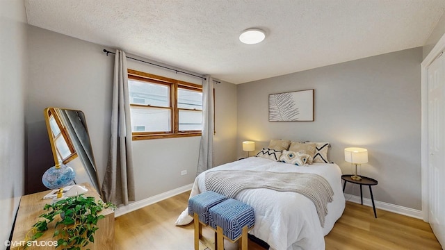 2701 S Hillock Ave, Chicago, IL 60608 - bedroom featuring light wood finished floors and a textured ceiling