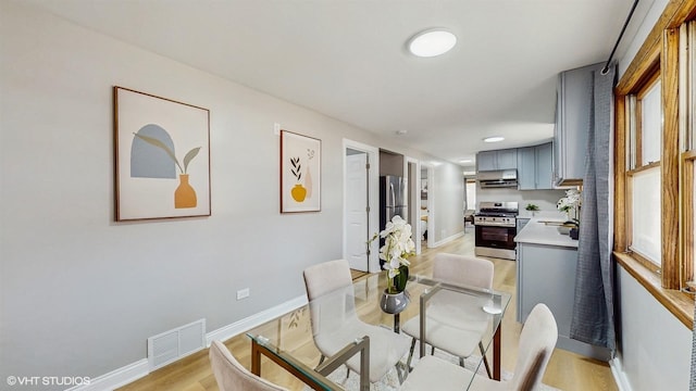 2701 S Hillock Ave, Chicago, IL 60608 - dining room featuring light wood finished floors and baseboards