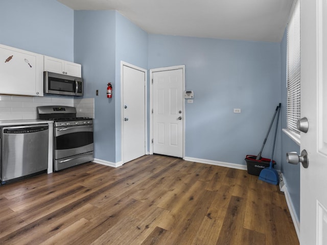 16322 Justine St, Markham, IL 60428 - kitchen featuring appliances with stainless steel finishes, white cabinetry, backsplash, dark wood-style flooring, and light countertops