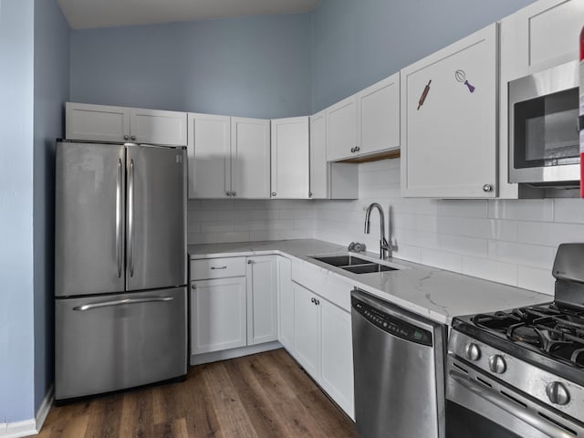 16322 Justine St, Markham, IL 60428 - kitchen featuring appliances with stainless steel finishes, decorative backsplash, white cabinets, and light stone counters