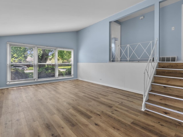 16322 Justine St, Markham, IL 60428 - spare room featuring lofted ceiling, wood finished floors, and stairs