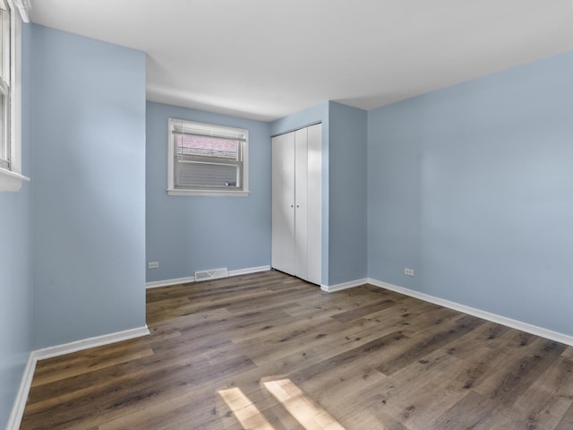 16322 Justine St, Markham, IL 60428 - unfurnished bedroom featuring wood finished floors and a closet