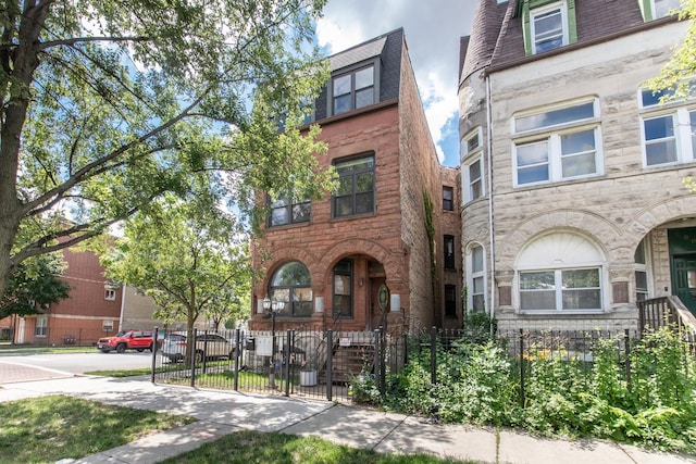 2901 W Washington Blvd Unit 2, Chicago, IL 60612 - view of property featuring mansard roof, a fenced front yard, and a gate