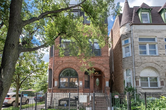 2901 W Washington Blvd Unit 2, Chicago, IL 60612 - view of front of property featuring stone siding, a gate, and a fenced front yard
