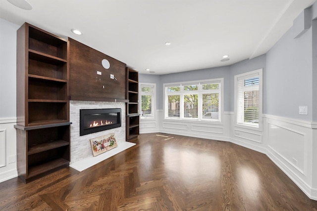 2040 N Laporte Ave, Chicago, IL 60639 - unfurnished living room with wainscoting, a glass covered fireplace, and a decorative wall