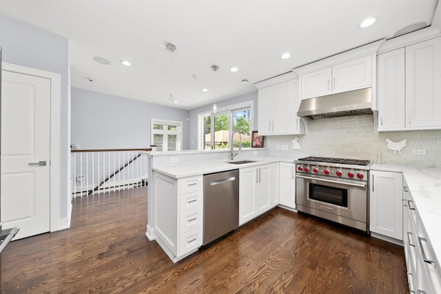 2040 N Laporte Ave, Chicago, IL 60639 - kitchen featuring appliances with stainless steel finishes, under cabinet range hood, dark wood-style flooring, a peninsula, and recessed lighting