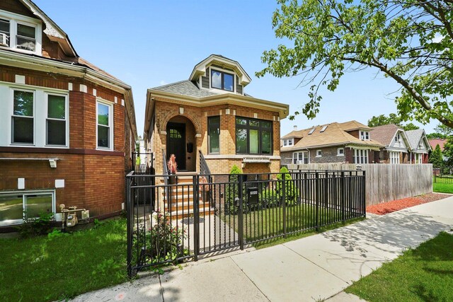 2040 N Laporte Ave, Chicago, IL 60639 - view of front of property featuring brick siding, a fenced front yard, a gate, and a residential view