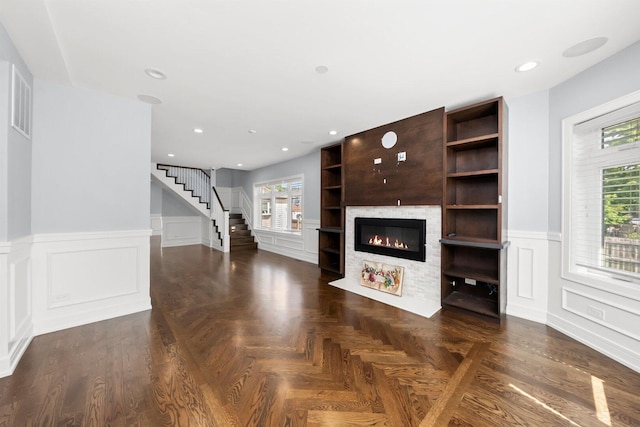 2040 N Laporte Ave, Chicago, IL 60639 - unfurnished living room featuring a glass covered fireplace, stairway, a decorative wall, a wainscoted wall, and recessed lighting