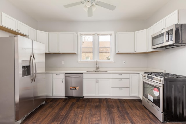 6132 S Justine St, Chicago, IL 60636 - kitchen with stainless steel appliances, a ceiling fan, white cabinetry, dark wood finished floors, and light countertops