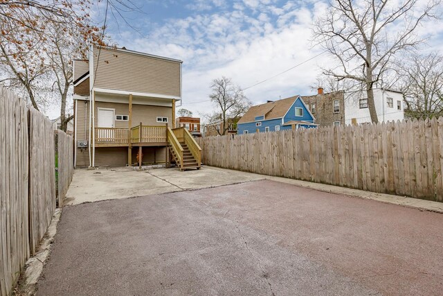 6132 S Justine St, Chicago, IL 60636 - back of property with stairway, a fenced backyard, a wooden deck, and a patio area