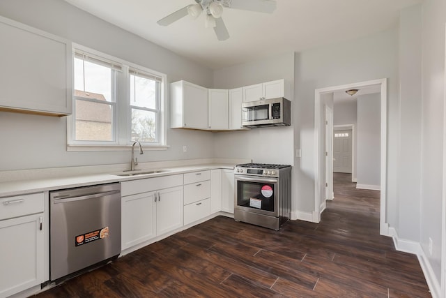 6132 S Justine St, Chicago, IL 60636 - kitchen featuring stainless steel appliances, ceiling fan, white cabinets, light countertops, and dark wood-style floors