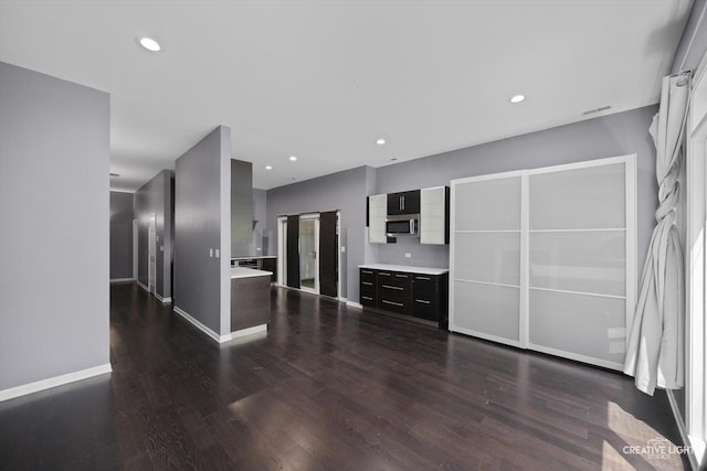 3312 W Beach Ave Unit 1, Chicago, IL 60651 - unfurnished living room featuring dark wood-style flooring and recessed lighting