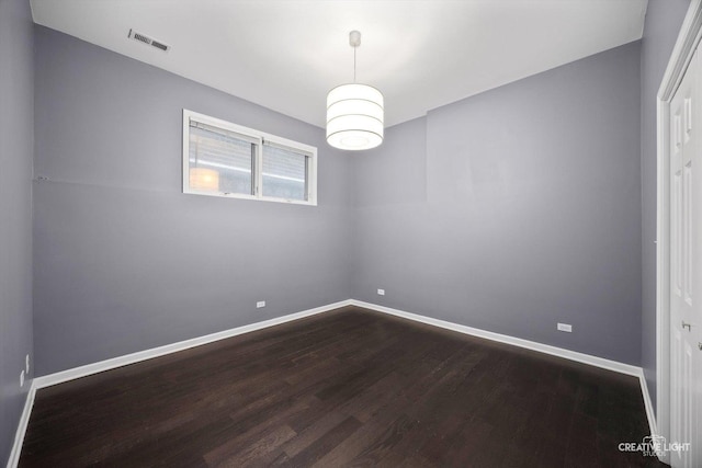 3312 W Beach Ave Unit 1, Chicago, IL 60651 - empty room featuring dark wood-style flooring and baseboards
