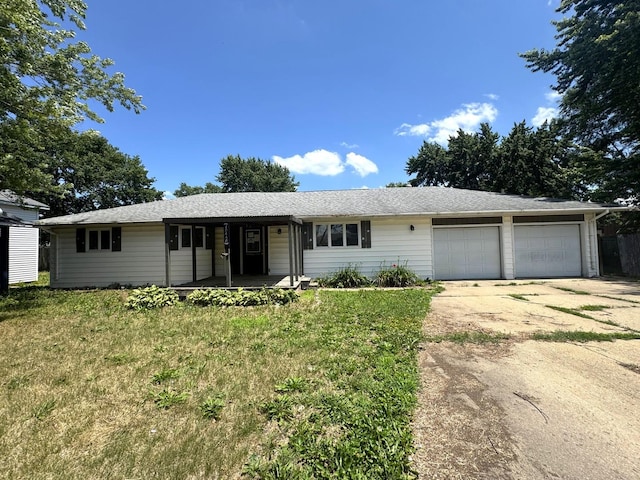 10440 Hussung Dr, Rock Falls, IL 61071 - ranch-style house with a porch, an attached garage, concrete driveway, and a front lawn