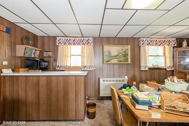 305 Milburn Ave, Crete, IL 60417 - kitchen with black microwave, a drop ceiling, plenty of natural light, brown cabinetry, and wooden walls