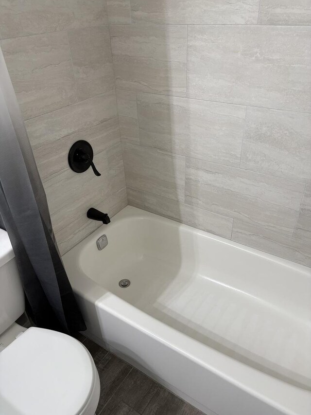 14949 Lakeview Dr Unit 204, Orland Park, IL 60462 - bathroom featuring shower / bathtub combination with curtain and wood finished floors