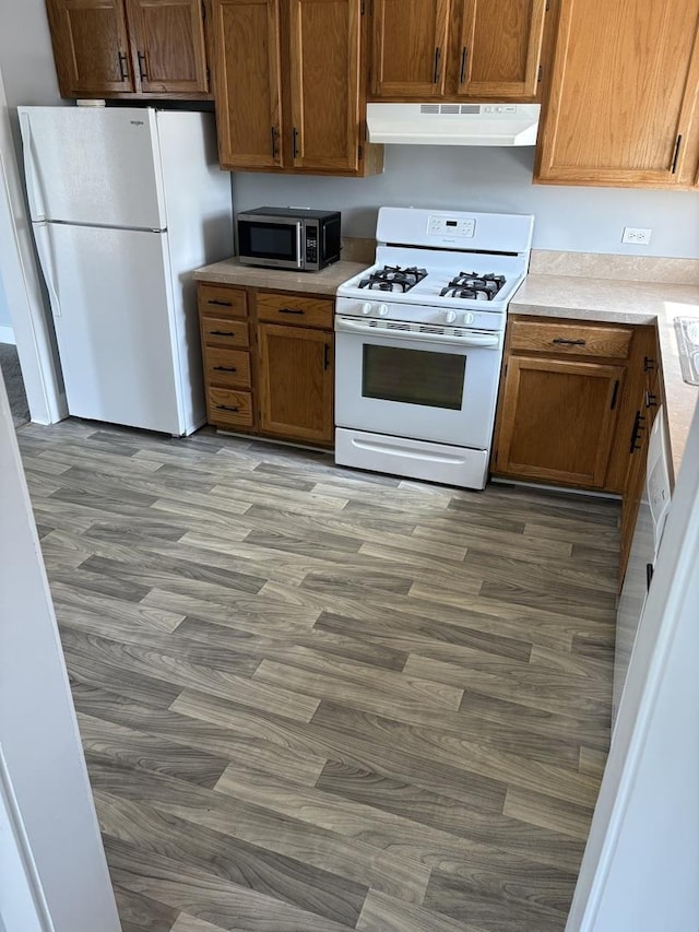 14949 Lakeview Dr Unit 204, Orland Park, IL 60462 - kitchen featuring white appliances, under cabinet range hood, wood finished floors, light countertops, and brown cabinets