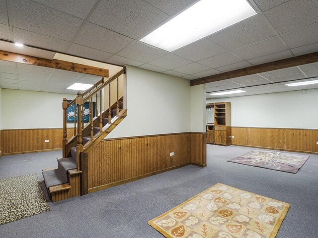 18036 Crystal Ln, Lansing, IL 60438 - finished basement featuring a wainscoted wall, a paneled ceiling, stairs, wooden walls, and carpet