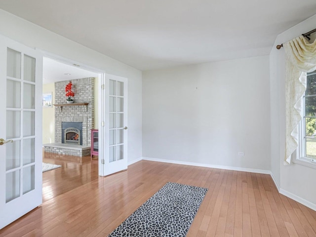18036 Crystal Ln, Lansing, IL 60438 - unfurnished living room featuring french doors, hardwood / wood-style flooring, and a fireplace